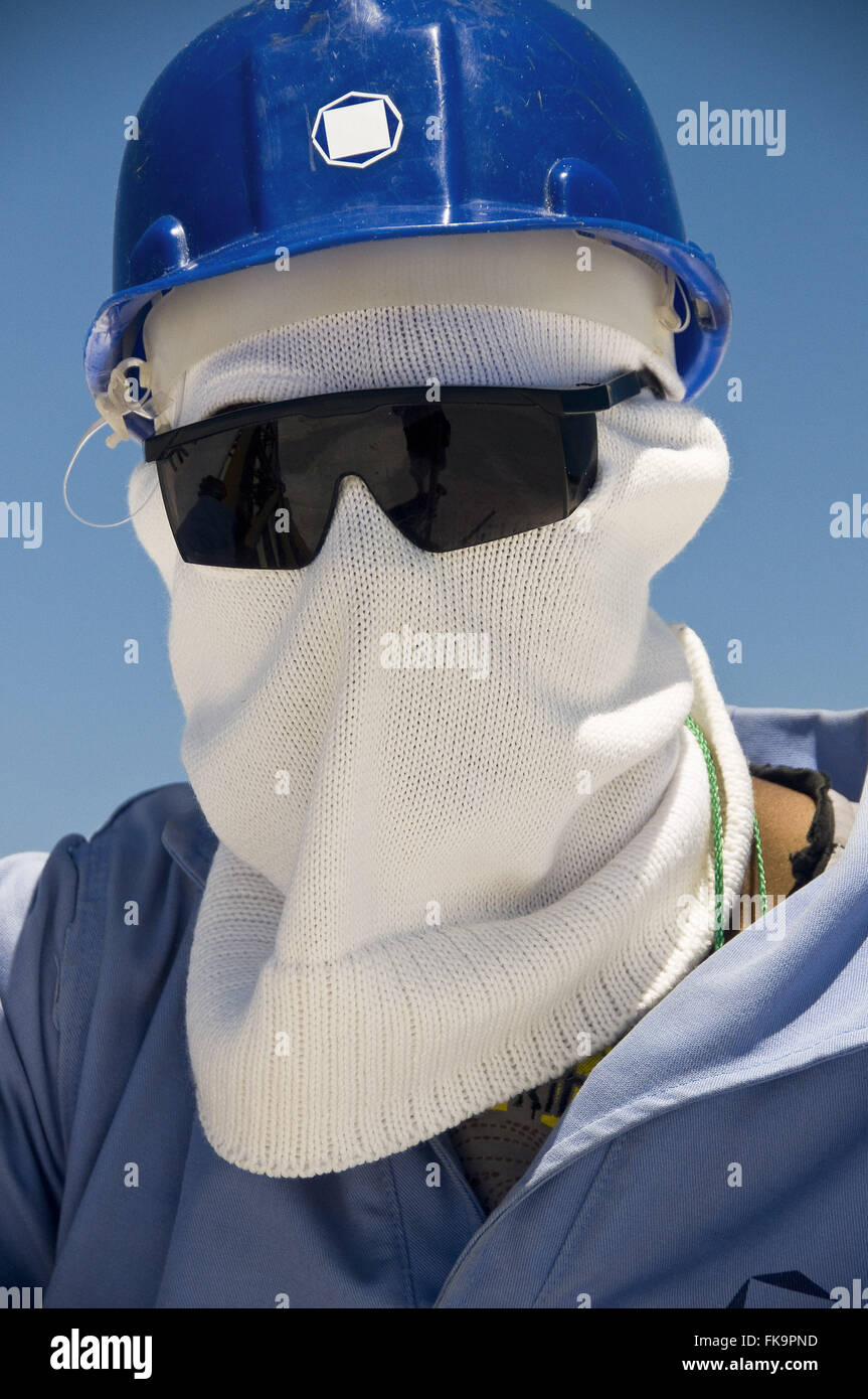 Soluzione salina Operario utilizzando PPE - equipaggiamento protettivo personale - in soluzione salina coastal Natal Foto Stock