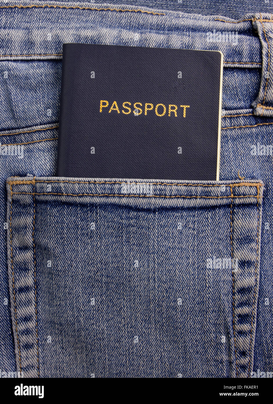 Un generico passaporto blu nella tasca posteriore di una coppia di sbiadito blu jeans denim. Foto Stock