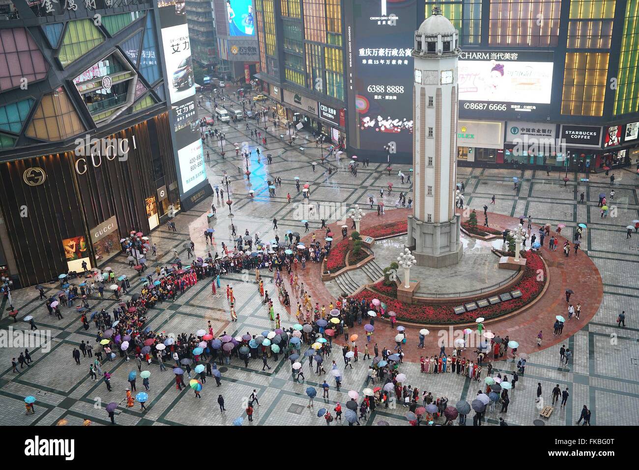 Chongqing Cina. 8 Mar, 2016. Le persone si radunano a Jiefangbei strada pedonale per guardare un cheongsam show celebra la Giornata internazionale della donna a Chongqing, sud-ovest della Cina, 8 marzo 2016. Un cheongsam mostra che ha visto la partecipazione di donne di diverse età e questo fu tenuto qui il martedì. Credito: Chen Cheng/Xinhua/Alamy Live News Foto Stock