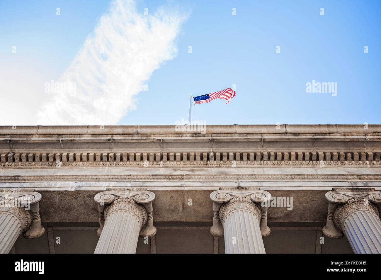 Guardando verso l'alto la bandiera americana sulla parte superiore di un edificio a Washington DC Foto Stock