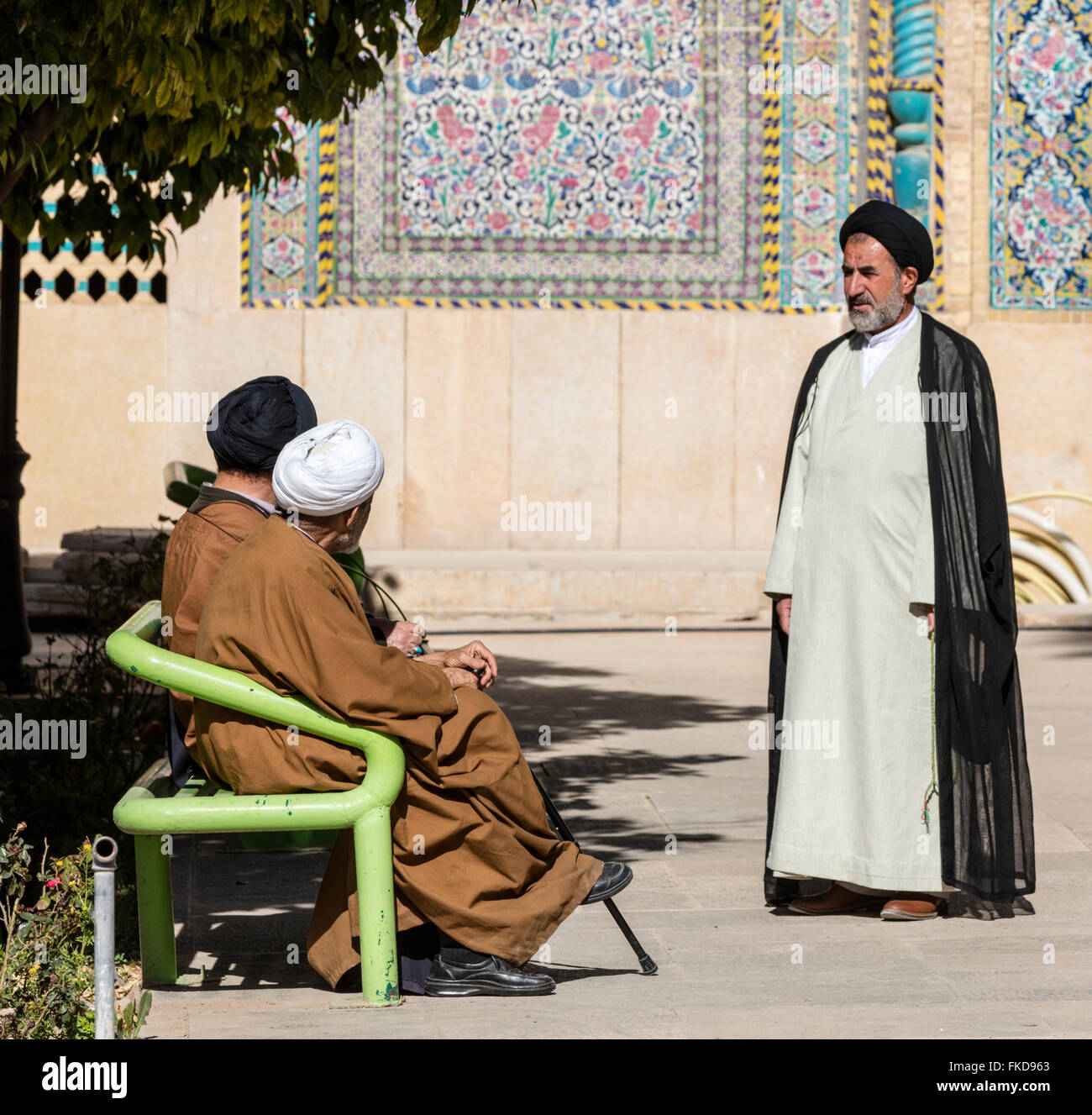 Tre mullah è impegnato in conversazione, il cortile del Khan madrasa, Shiraz, Iran Foto Stock