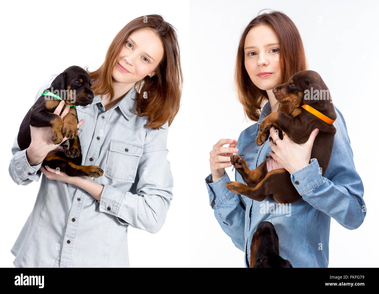 Bella donna detiene il doberman cucciolo di cane sulle sue mani, isolato su bianco Foto Stock