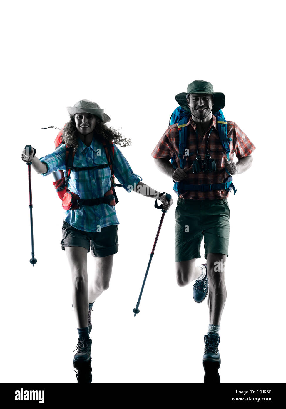 Una coppia caucasica trekker trekking in esecuzione felice in silhouette isolati su sfondo bianco Foto Stock