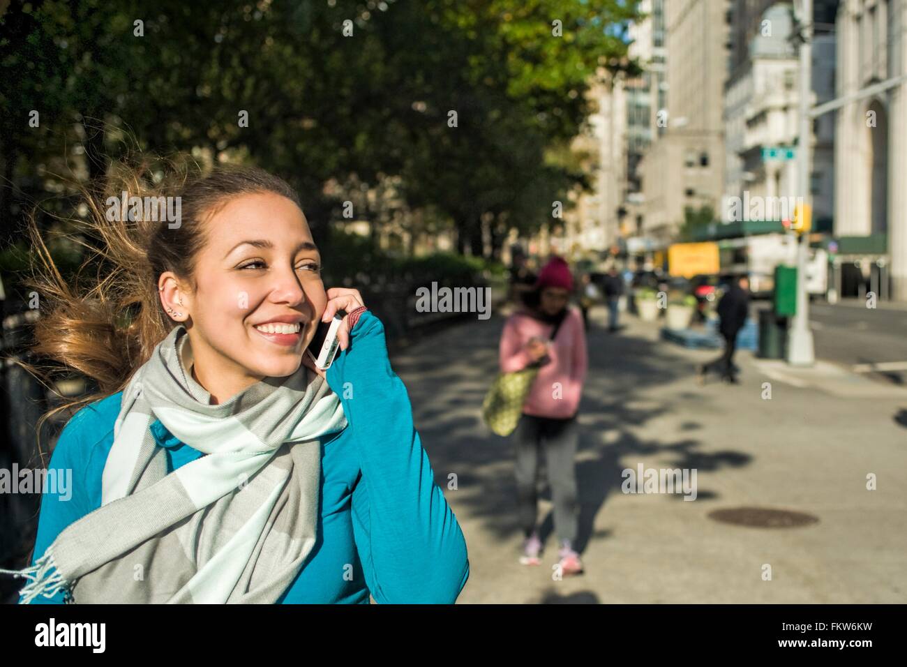 Giovane donna utilizza lo smartphone in posizione di parcheggio Foto Stock