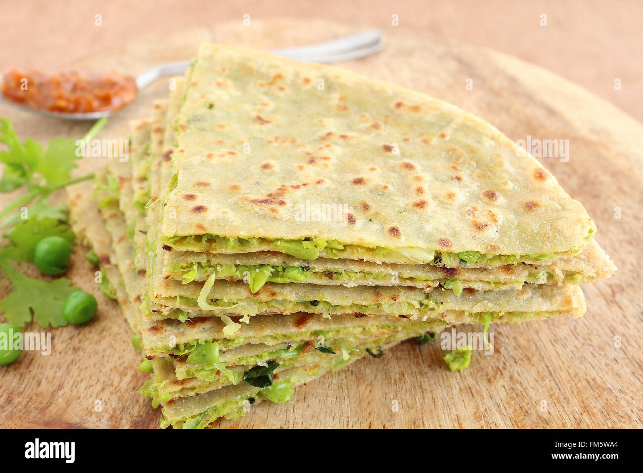 Il cibo indiano paratha, o piatto pane ottenuto da farina di grano e la massa di foglie di coriandolo e piselli pasta. Foto Stock