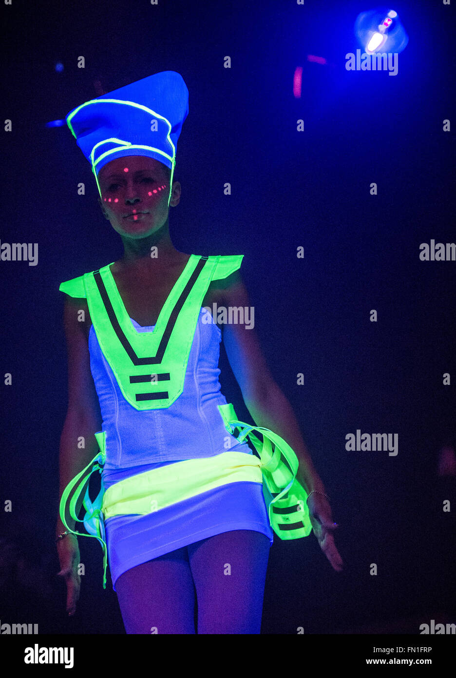 Un modello di passeggiate attraverso la passerella durante un blacklight fashion show per la apertura della 'Luminale' spettacolo di luci a Offenbach, Germania, 12 marzo 2016. Questo anno il Luminale avviene dal 13 al 18 marzo 2016 e presenta circa 200 impianti di luce a Francoforte e Offenbach. Foto: BORIS ROESSLER/dpa Foto Stock