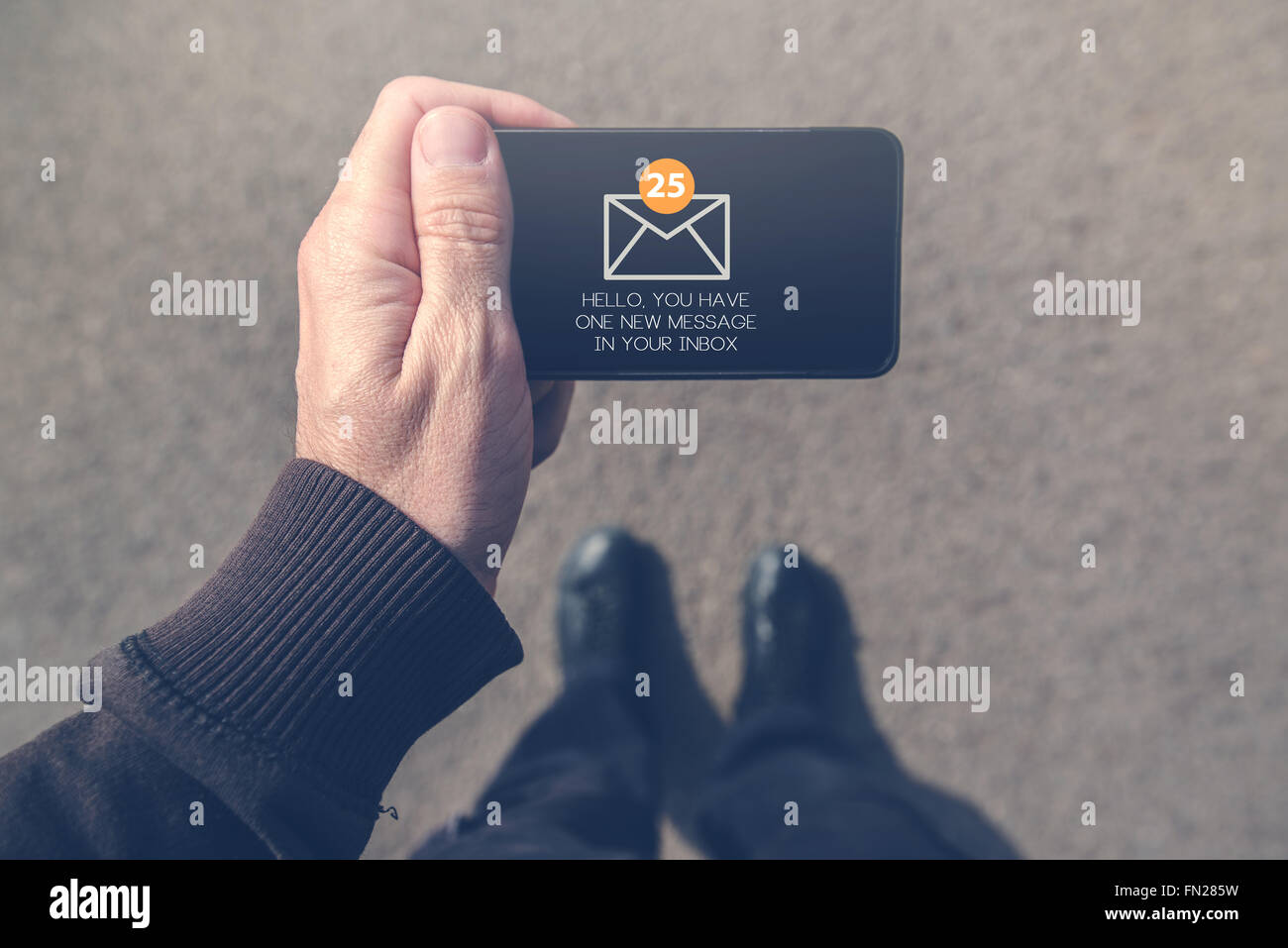 L uomo ha ricevuto messaggio di posta elettronica sul Mobile smartphone mentre si cammina sulla strada, vista dall'alto pov immagine in prospettiva. Foto Stock