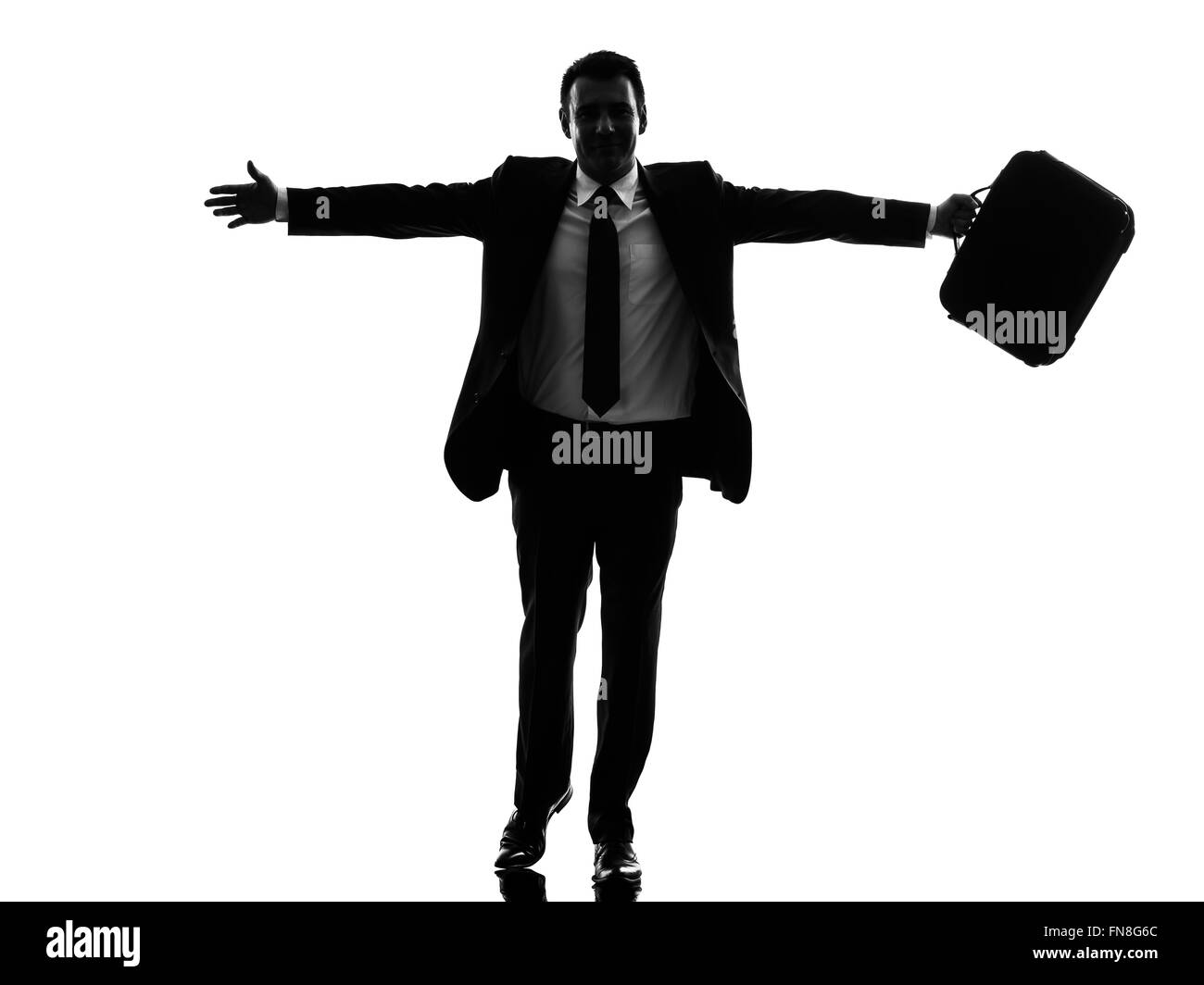 Un caucasian business man in esecuzione felice braccia tese in silhouette su sfondo bianco Foto Stock
