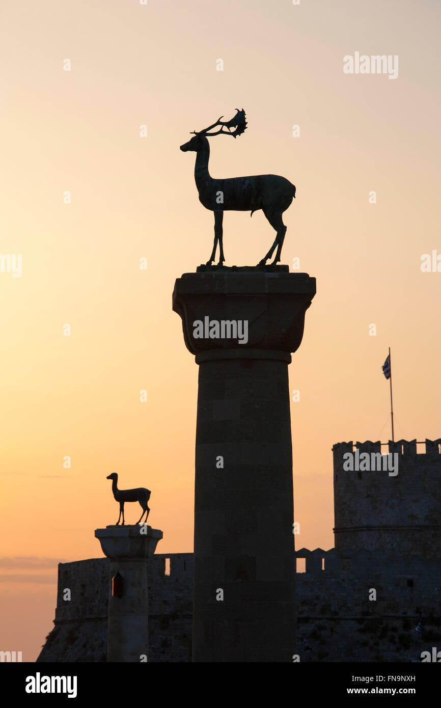 La città di Rodi, rodi, Egeo Meridionale, Grecia. Statue di daini all'ingresso Mandraki Harbour, sunrise. Foto Stock