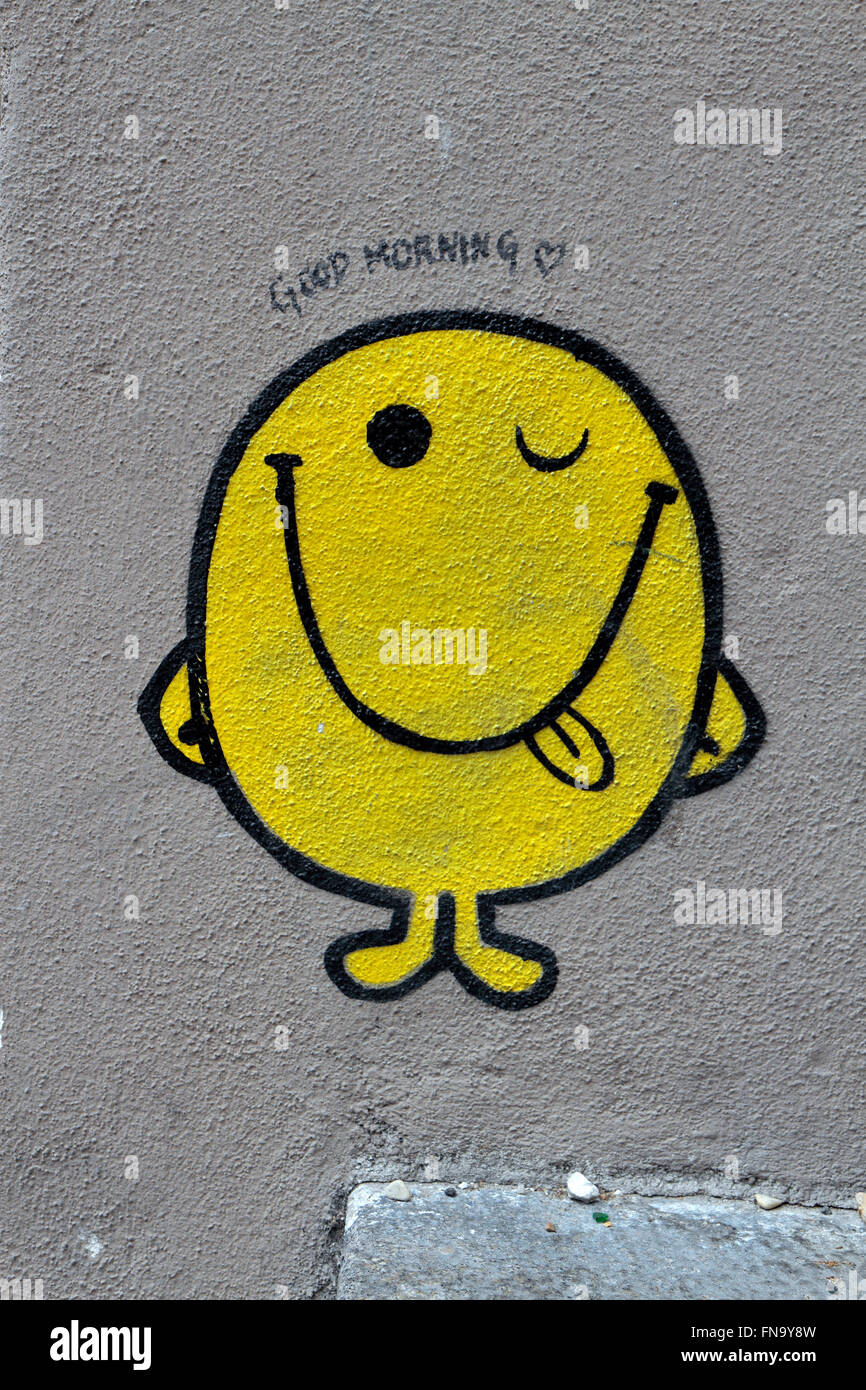 Un modo divertente di Mister uomini tipo graffiti giallo, winking carattere nel quartiere a luci rosse di Pigalle () di Parigi, Francia. Foto Stock