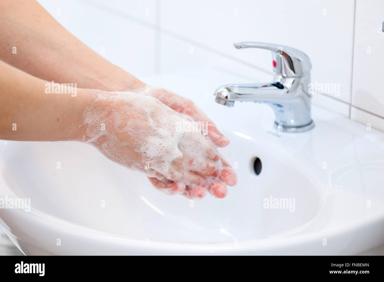 Il lavaggio delle mani con sapone in acqua corrente. Igiene e pulizia delle mani. Foto Stock