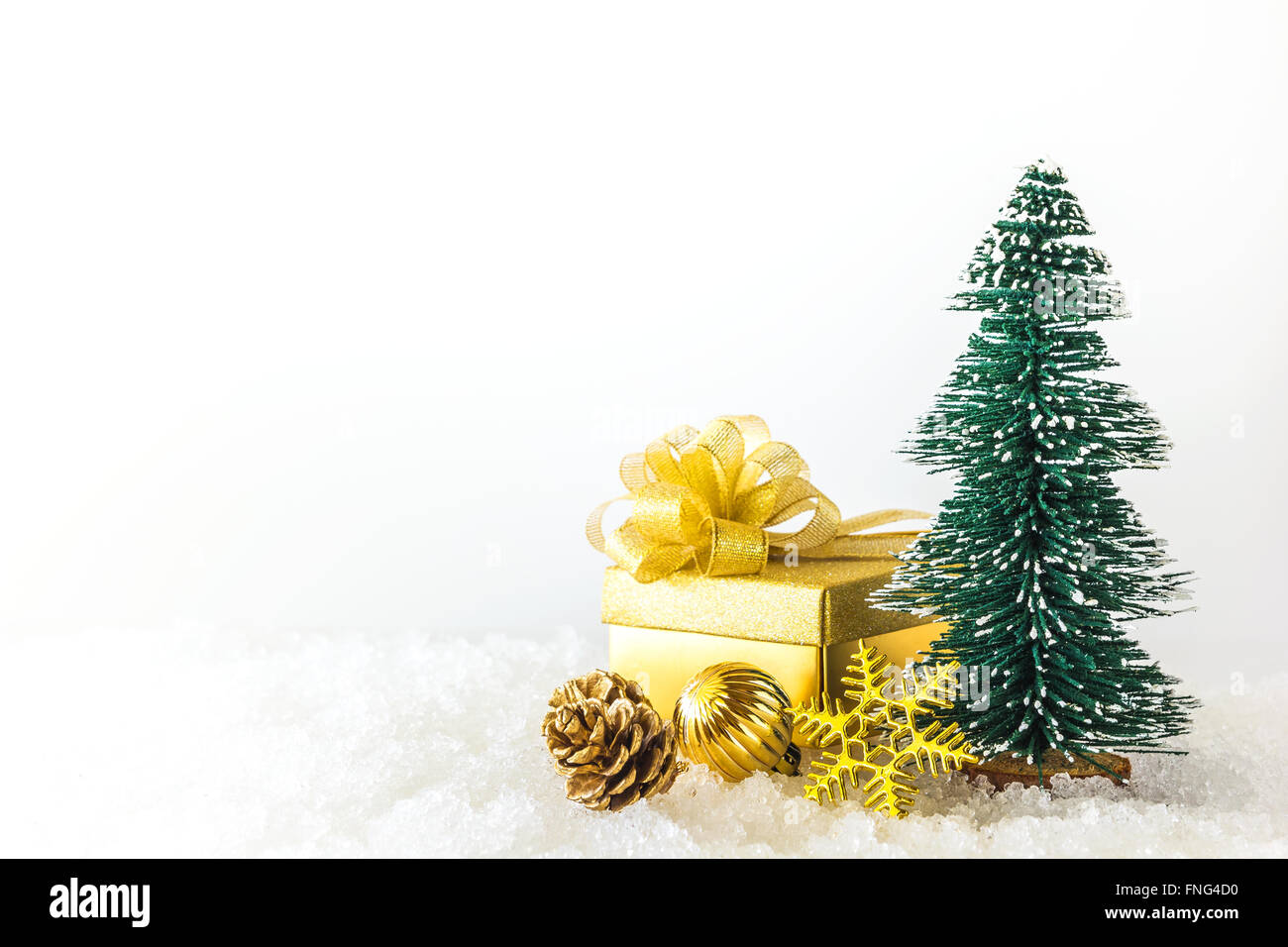 Piccolo albero di natale e decorazioni di Natale sulla massa di neve Foto Stock