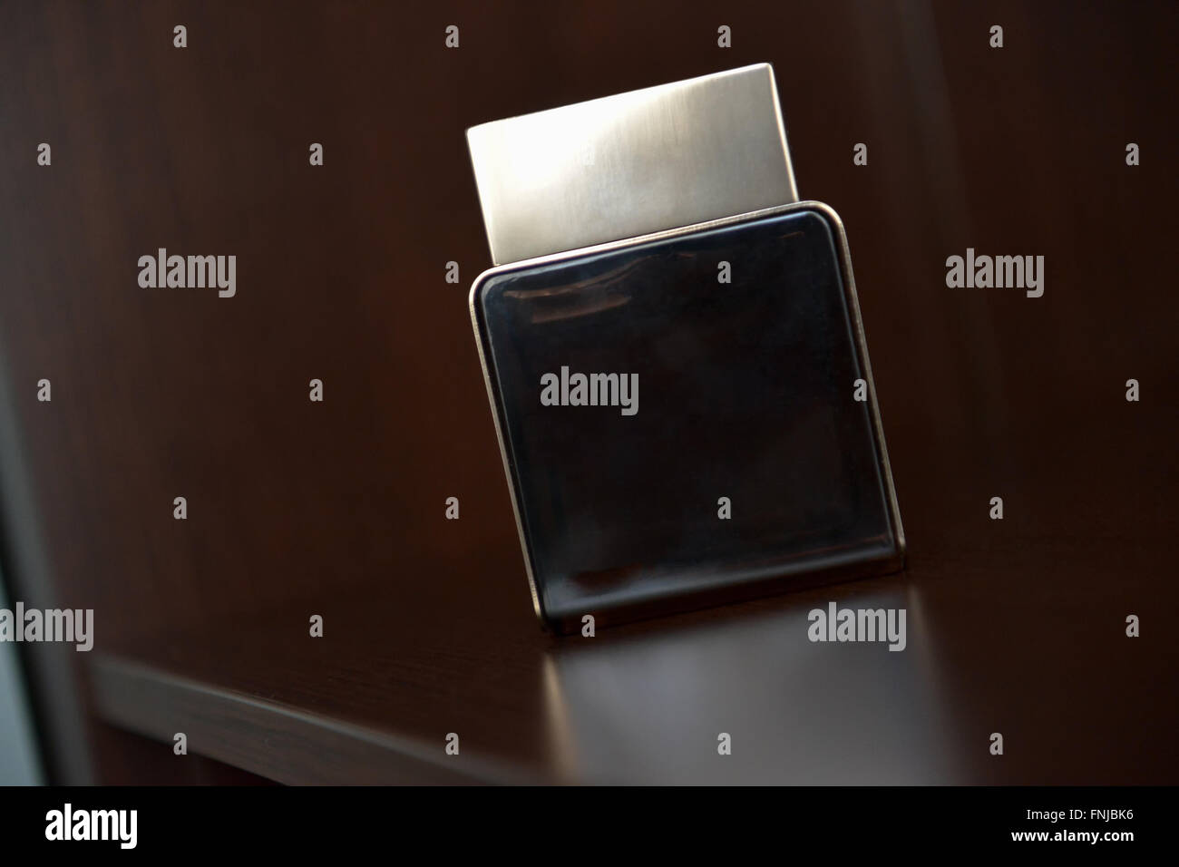 Profumo maschile seduto sul ripiano di luce naturale Foto Stock