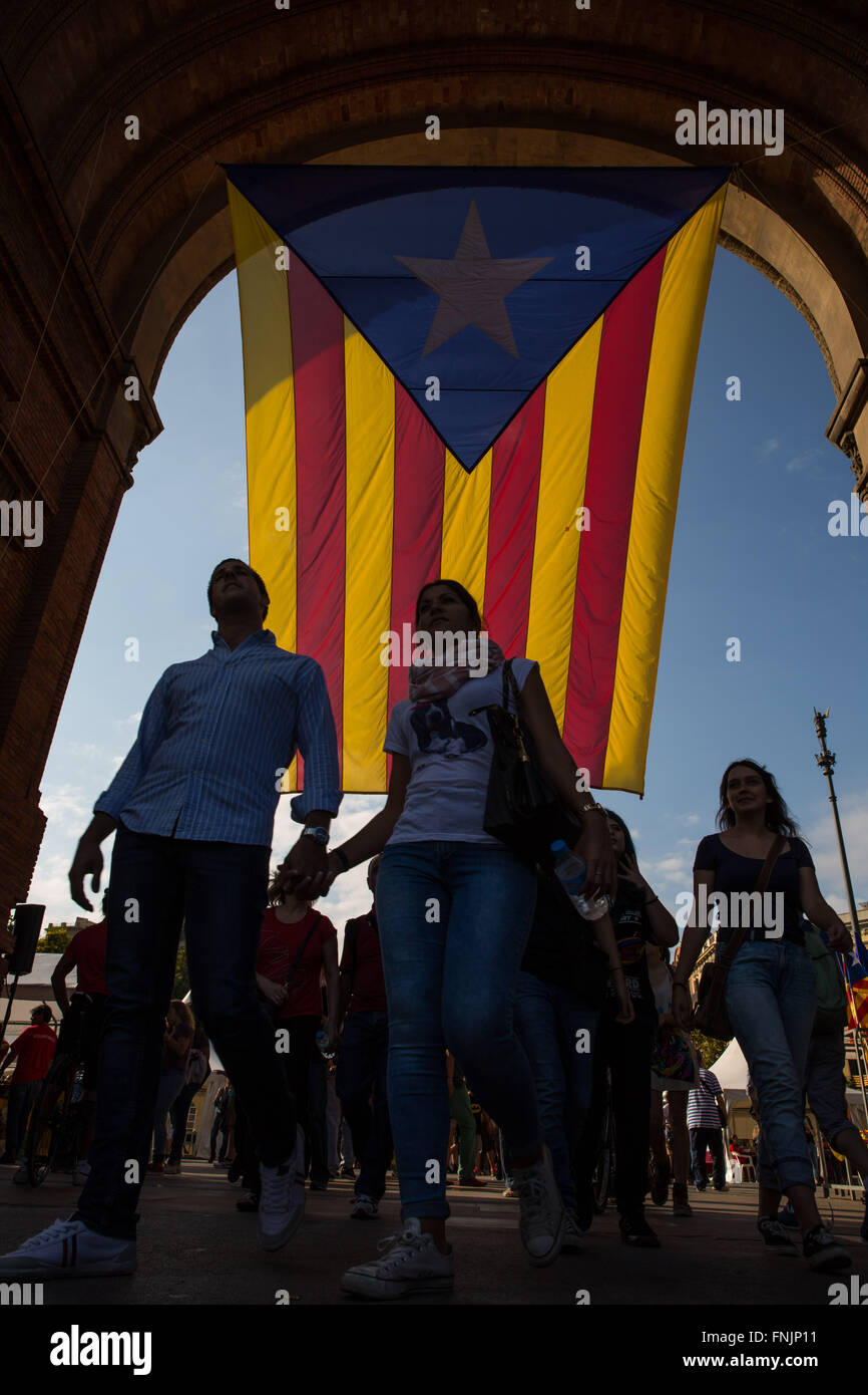 Sep 11, 2015 - Barcellona, Spagna - un paio di passeggiate mano nella mano in silhouette come persone marzo indossando la bandiera catalana all'Arc de Triomf di Barcellona. Barcellona è stato un mare di rosso e giallo come la folla portando bandiere separatisti hanno marciato in città per celebrare il catalano Giornata Nazionale. Gli organizzatori spera di attirare almeno mezzo milione di persone per un pro-indipendenza rally usando lo slogan 'cominciamo a costruire un nuovo paese". (Credito Immagine: © Ruaridh Stewart/ZUMA filo/ZUMAPRESS.com) Foto Stock