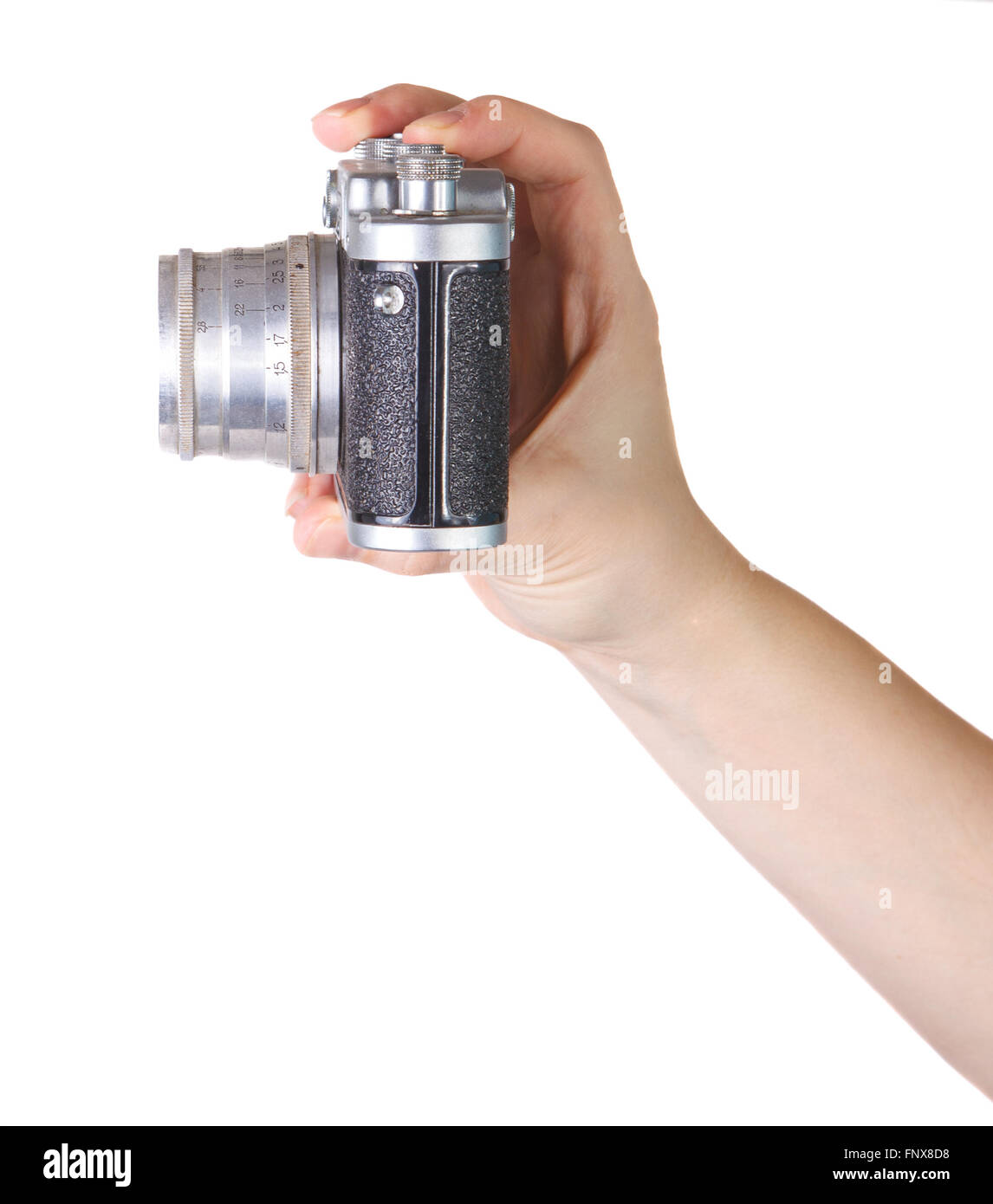 Vecchia macchina fotografica nella donna la mano su uno sfondo bianco Foto Stock