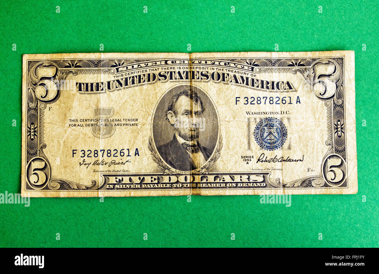 Un molto usato e ripiegate U.S. Cinque Dollari che è una delle piccole dimensioni di argento certificati rilasciati tra il 1928 e il 1957. Si certifica che non vi era in deposito presso il Tesoro degli Stati Uniti d'America "cinque dollari in argento pagabile al portatore on demand." Questa carta moneta è stata emessa soltanto in $1, $5 e $10 denominazioni. Di maggiori dimensioni argento certificati sono stati emessi in precedenza tra il 1878 e il 1923 e ha promesso il pagamento da parte del governo degli STATI UNITI Tesoriere nella effettiva dollari d'argento. Certificati d'argento sono stati sostituiti dalla Federal Reserve Note a partire dagli anni sessanta. Certificati di rimanere legale. Foto Stock