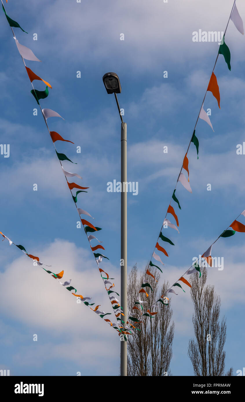 Tricolore irlandese bunting vola overhead su Belfast's Falls Road. Foto Stock