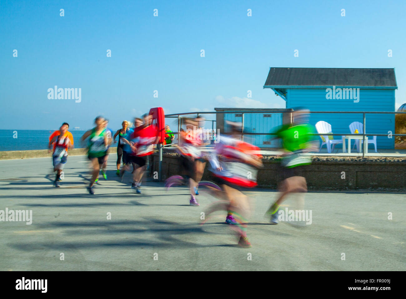 Fleetwood lungomare corsa; corridori sfocati in movimento sulla spianata costiera. Velocità di esecuzione di 10k Charity. I corridori si sono riuniti sul lungomare per una corsa di beneficenza organizzata dal Rotary Club di Fleetwood, Lancashire, Regno Unito Foto Stock