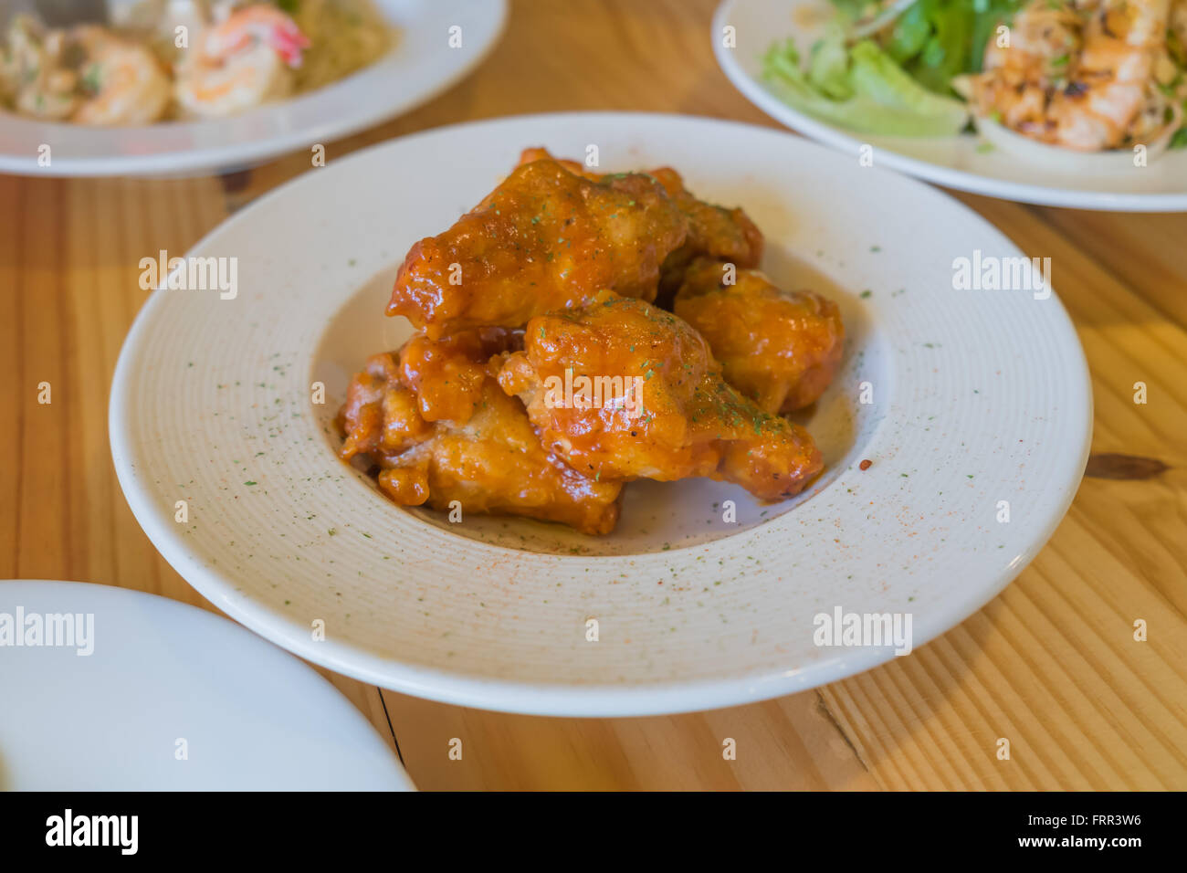 Le ali di pollo croccanti sul piatto bianco Foto Stock