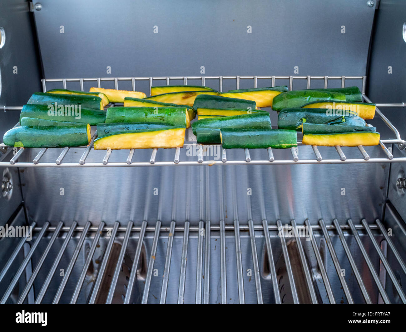 Zucchine verde cottura su barra di acciaio inossidabile b que Foto Stock