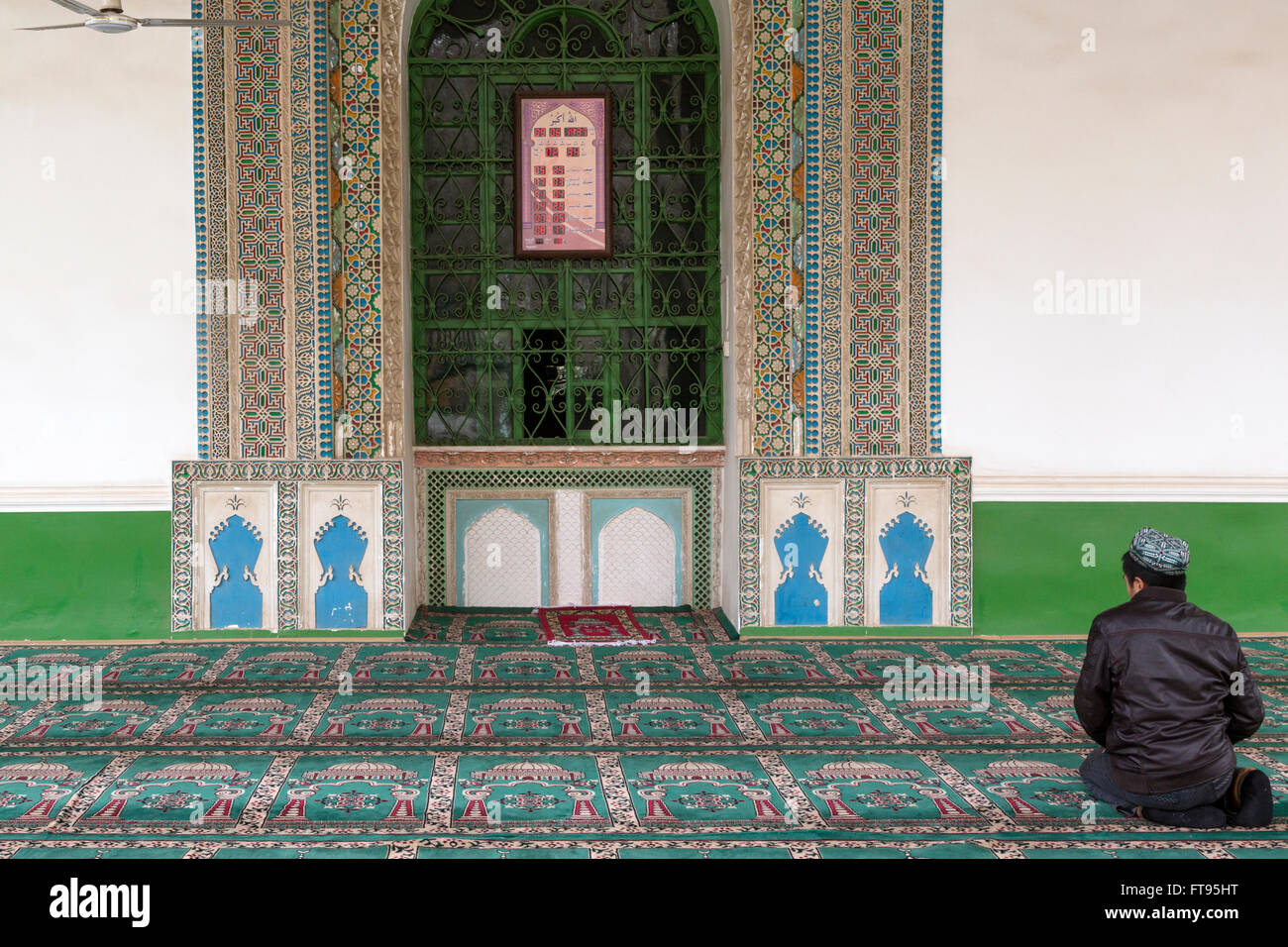 Un uomo che prega nel più grande in Cina alla Moschea Id kah di Kashgar city Foto Stock