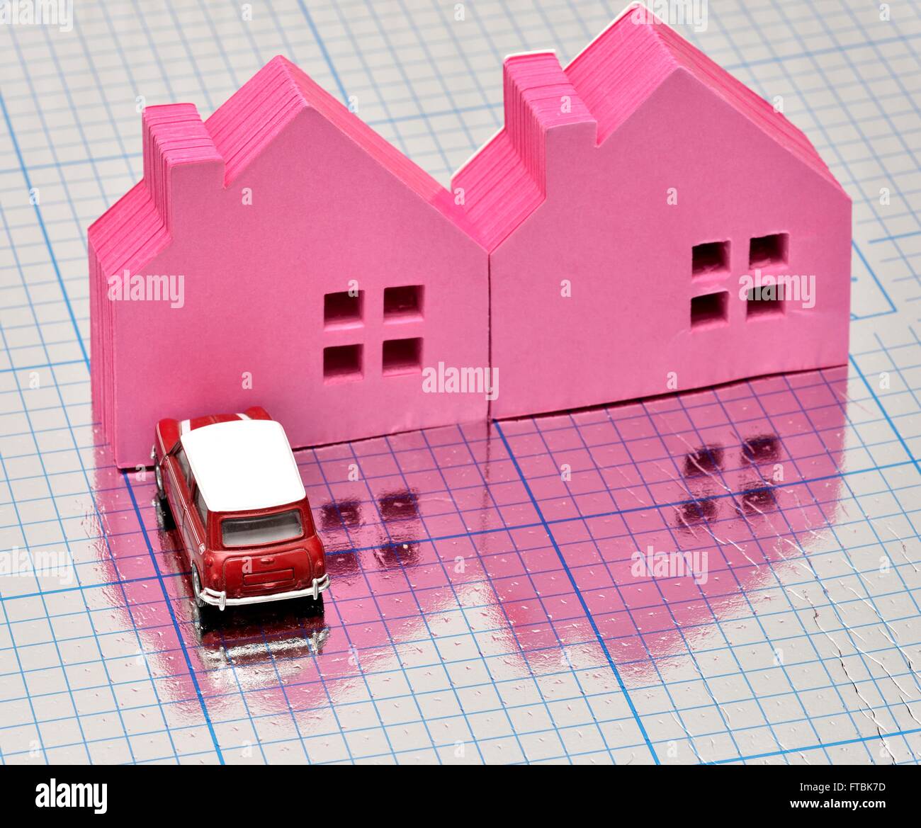 Due case di rosa con una vettura parcheggiata di fronte su un quadrato blu superficie lucida Foto Stock
