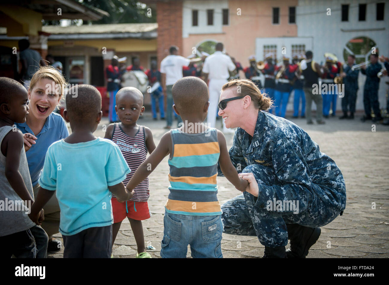 150314-N-JP249-213 Douala Camerun (14 marzo 2015) Lt. Sherrie Flippin e i militari Sealift Command/Commander, Task Force 63's public affairs officer, Meghan Henderson, sinistra, danza con bambini camerunesi Marzo 14, 2015 a Douala Camerun, mentre nella porta per supportare Africa Partnership stazione. Africa Partnership, una stazione di collaborazione internazionali di programma per il potenziamento delle capacità, viene condotta in congiunzione con una distribuzione programmata dai militari Sealift il comando congiunto del ad alta velocità a nave USNS Spearhead (JHSV 1). (U.S. Foto di Marina di Massa lo specialista di comunicazione 2a classe Kenan Foto Stock