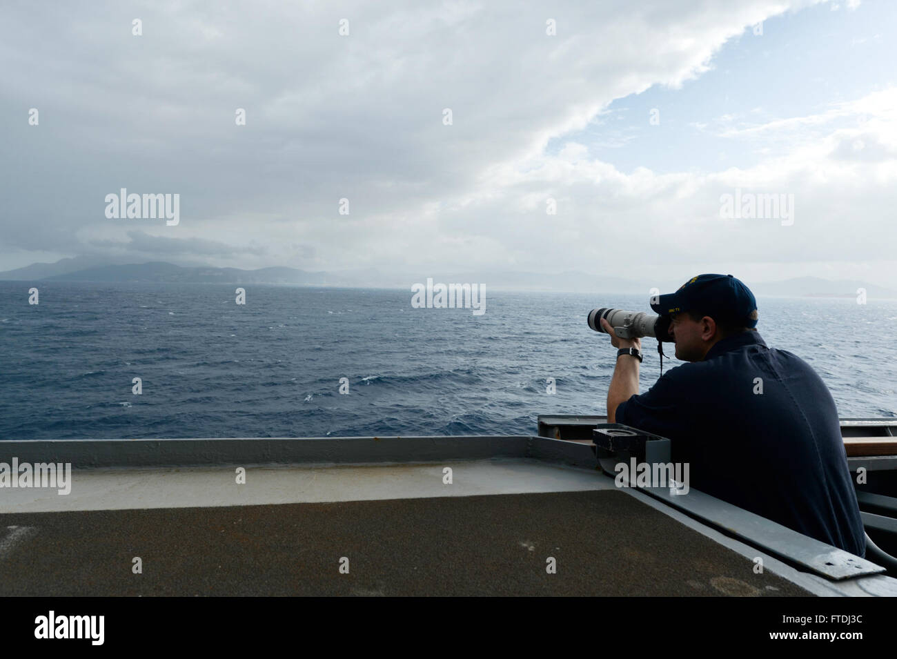Lo specialista di intelligence di prima classe James Friederichs, a bordo della USS Ross (DDG 71), cattura fotografie durante il transito della nave attraverso lo stretto di Gibilterra. La USS Ross, parte della 6th Fleet della Marina degli Stati Uniti, sta conducendo operazioni navali a sostegno della sicurezza nazionale degli Stati Uniti in Europa. Foto Stock