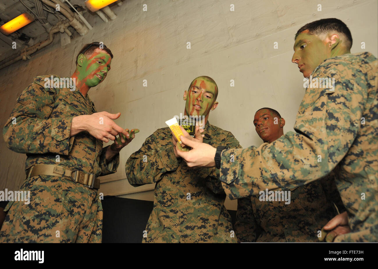 140223-N-IK431-002 OCEANO ATLANTICO (feb. 23, 2014) - Marines a bordo della USS Bataan (LHD 5) applicare vernice faccia in preparazione per un esercizio. Il Bataan anfibio gruppo Readiness è implementato il supporto le operazioni di sicurezza marittima, fornendo la risposta alle crisi, la capacità di aumentare il teatro la cooperazione in materia di sicurezza e di un avanzamento presenza navale negli Stati Uniti La marina di quinta e sesta flotta Area di responsabilità. (U.S. Foto di Marina di Massa Specialista comunicazione marinaio apprendista Aaron T. Kiser/rilasciato) Foto Stock