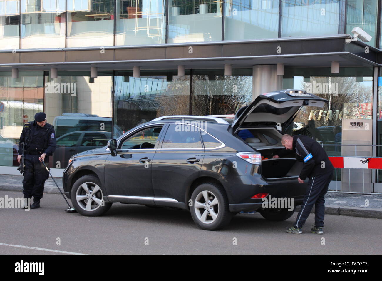 Quasi a mezzogiorno di lunedì 28 marzo 2016, la polizia ceca erano visti controllando ogni veicolo proveniente nel vialetto di Praga è un hotel Hilton Pobřežní sulla strada di fronte all'edificio degli uffici delle società di servizi professionali KPMG. Pobřežní Street è stato riempito con il popolo cinese il tifo per il Presidente Xi Jinping sul suo ufficiale visita di stato in Repubblica ceca a firmare accordi con Zeman. Il funzionario di polizia presso la parte anteriore del veicolo controllato la vettura contro bombe impiantati e di un altro funzionario di polizia in corrispondenza della parte posteriore della vettura ha controllato il bagagliaio della vettura contro le sostanze pericolose. Foto Stock