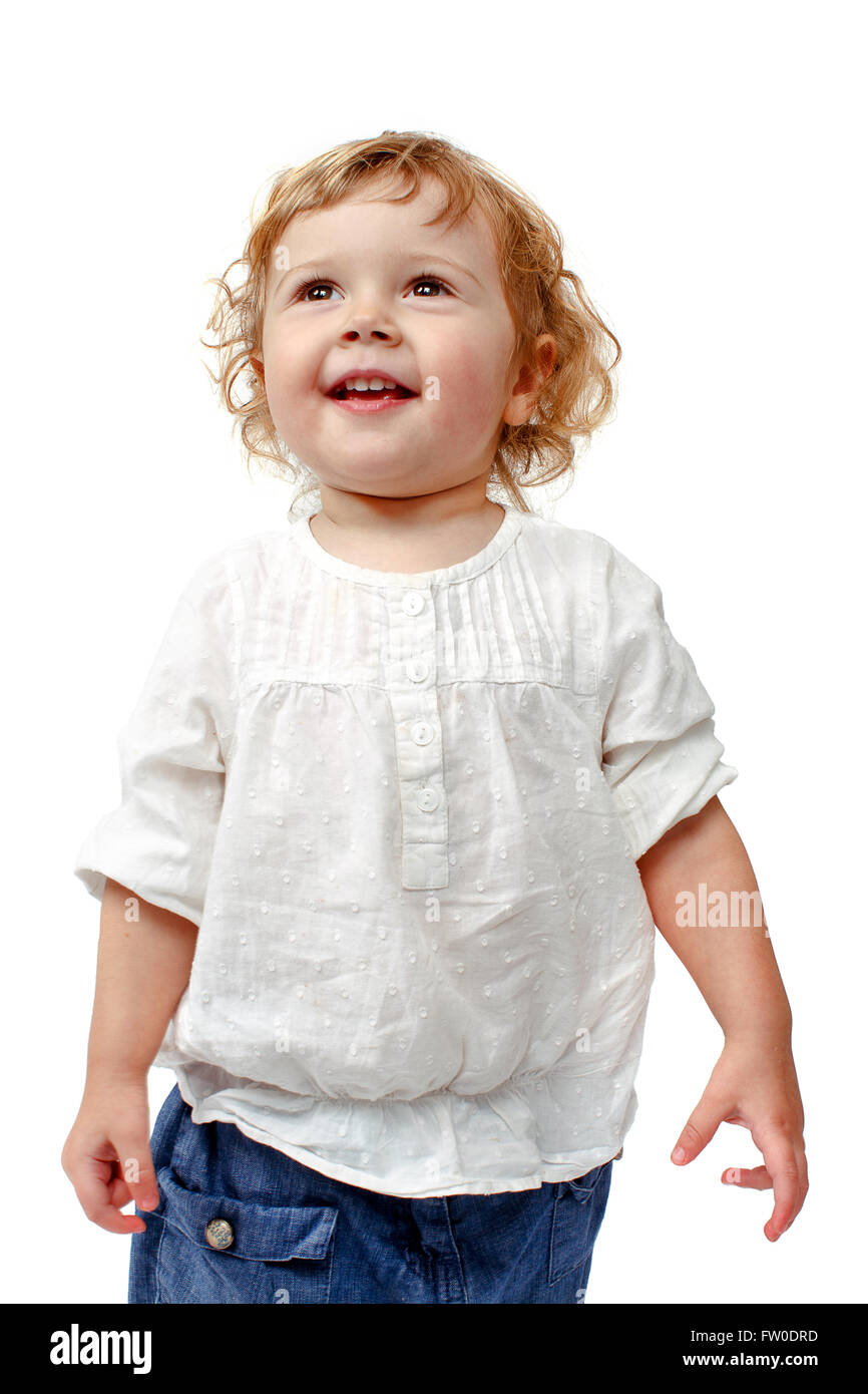 Giovani il bambino in piedi ad applaudire in interni e sorridente Foto Stock