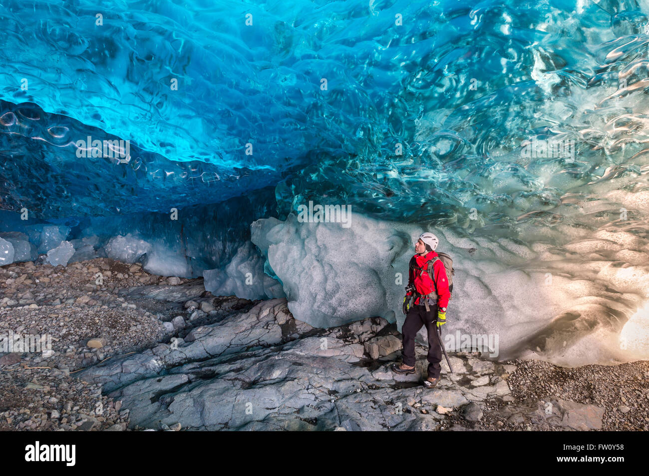 Ice Climber nella caverna di ghiaccio sotto il ghiacciaio Breidamerkurjokull, Islanda Orientale Foto Stock
