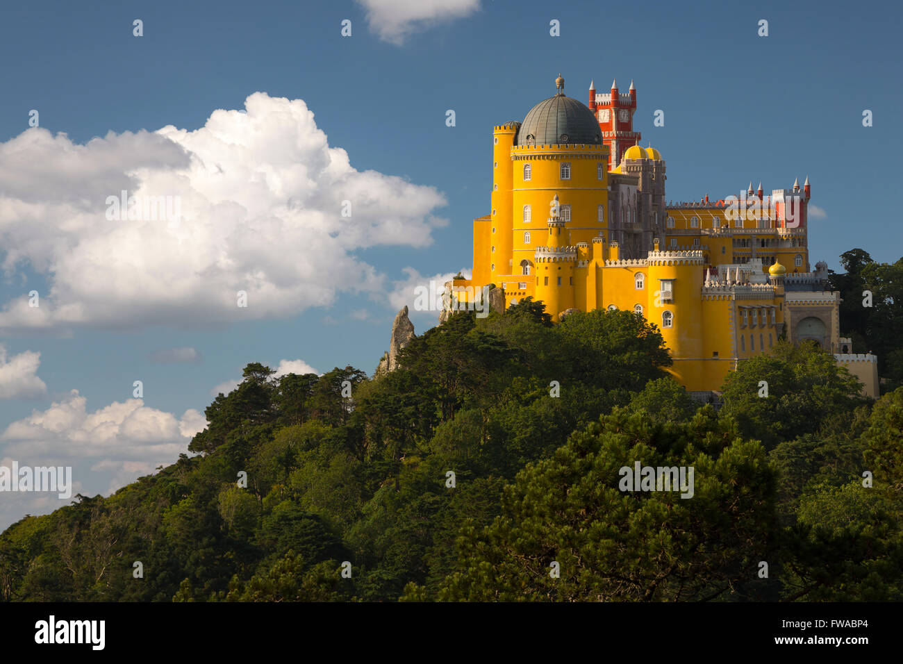 Il Portogallo. Sintra. La pena Palace su una rupe circondata da una foresta e nuvole Foto Stock