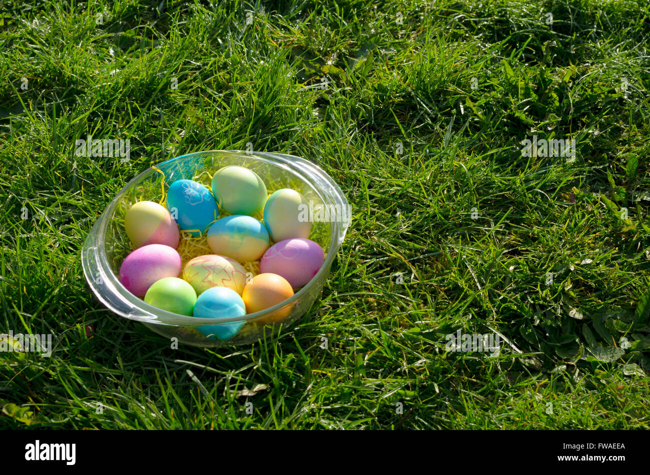 Una ciotola di uova di pasqua con colorati arte e bunny dipinti. Foto Stock