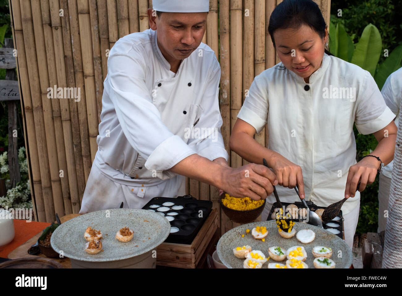 Six Senses Resort Koh Yao Noi, Phang Nga Bay, Thailandia, in Asia. Cooker facendo un Khanom Krok, coconout crema dessert. Sei sensi Foto Stock