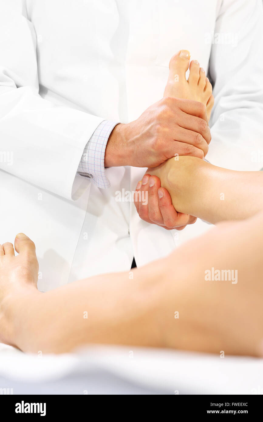 Fisioterapia, massaggi gambe. Medicina alternativa, agopressione. Chirurgo ortopedico esamina il piede di un paziente Foto Stock