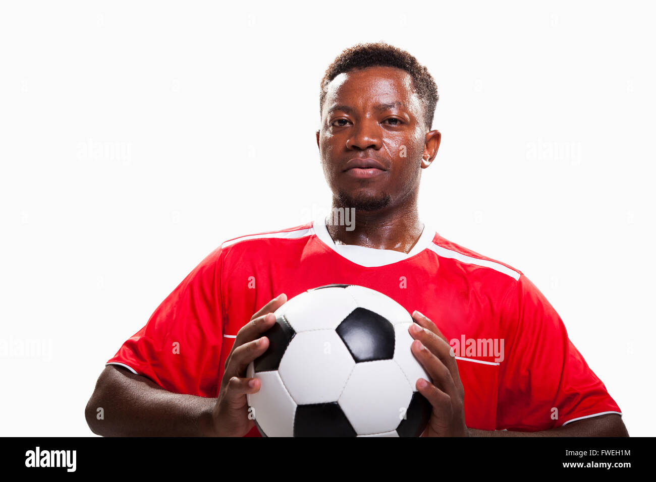Atleta con pallone da calcio Foto Stock