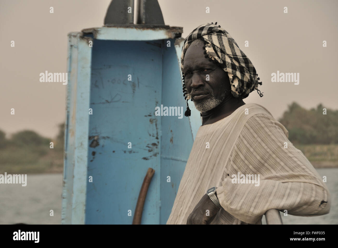 Uomo sulla traversata in traghetto e il Nilo, verso il vecchio Dongola Foto Stock