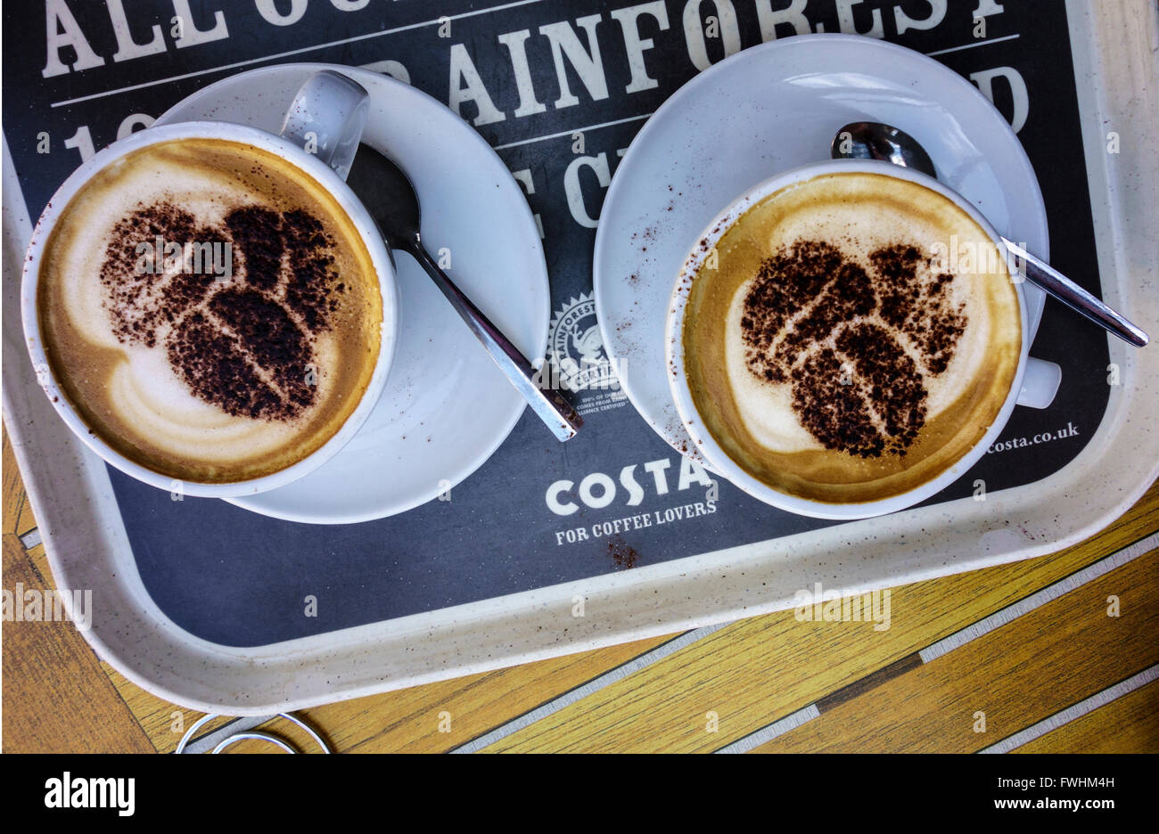 Due tazze di cappuccino Costa su una costa vassoio. Foto Stock