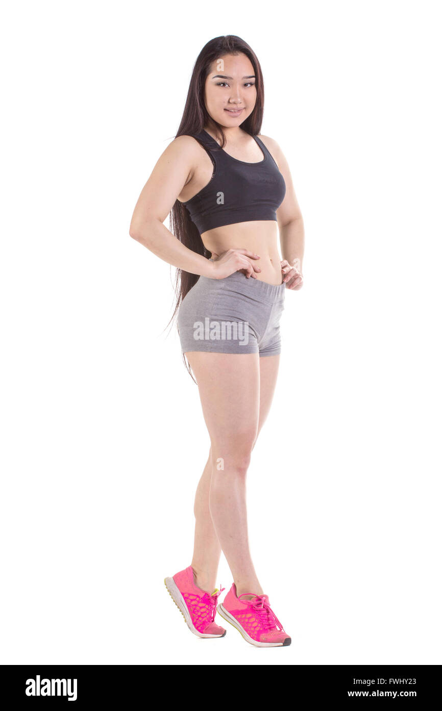 Splendida palestra oriental woman standing - isolato su uno sfondo bianco Foto Stock