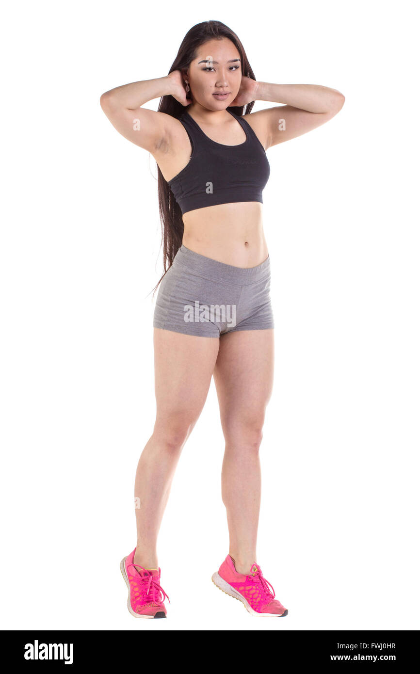 Splendida palestra oriental woman standing - isolato su uno sfondo bianco Foto Stock