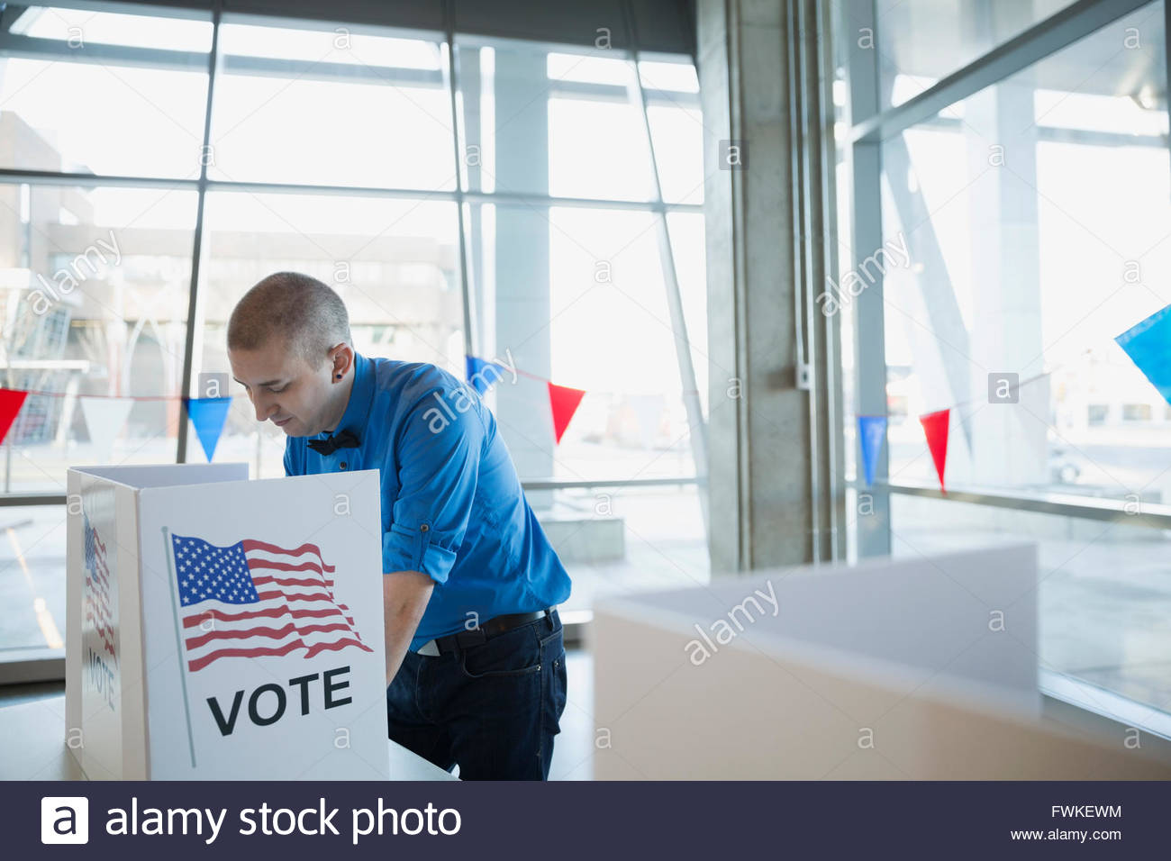 L'uomo bow tie in cabina di voto luogo di polling Foto Stock