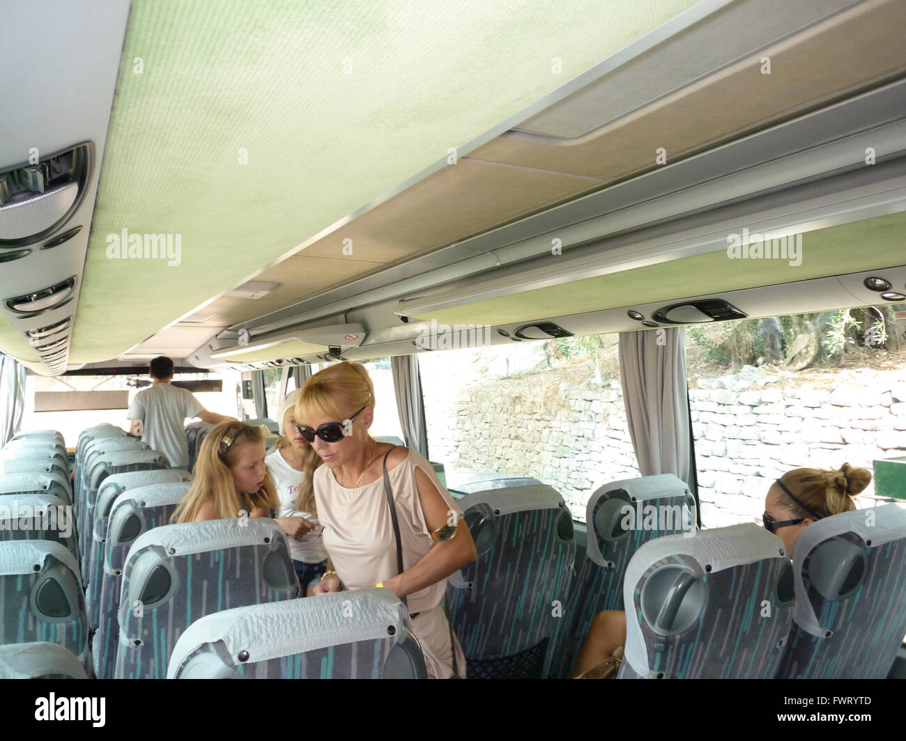 Signora cercando la sua sede su un bus locale autobus sull'isola di Corfu, Grecia Foto Stock