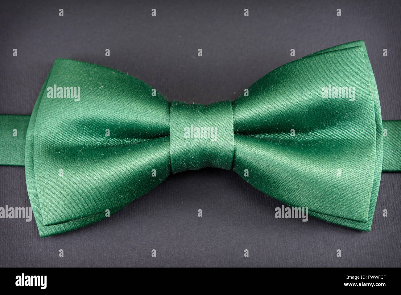 Green bow tie su sfondo scuro Foto Stock