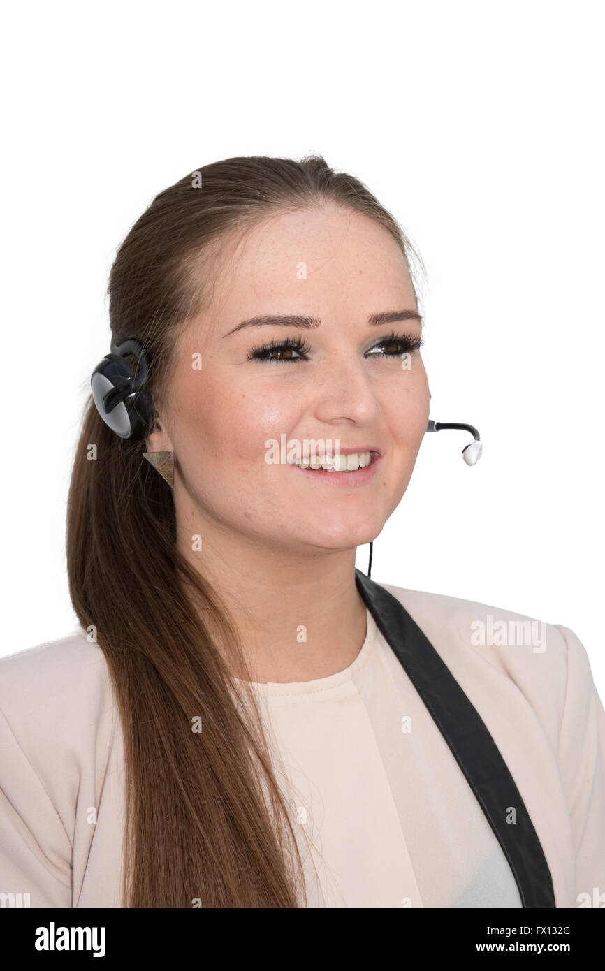 Un gentile operatore help desk in conversazione utilizzando un set di testa Foto Stock