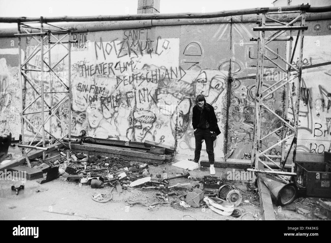 Archivio di immagine di una giovane donna di fronte a graffiti sui resti del muro di Berlino e Potsdamer Platz di Berlino, Germania, marzo 1994. Modello di rilascio disponibili. Foto Stock