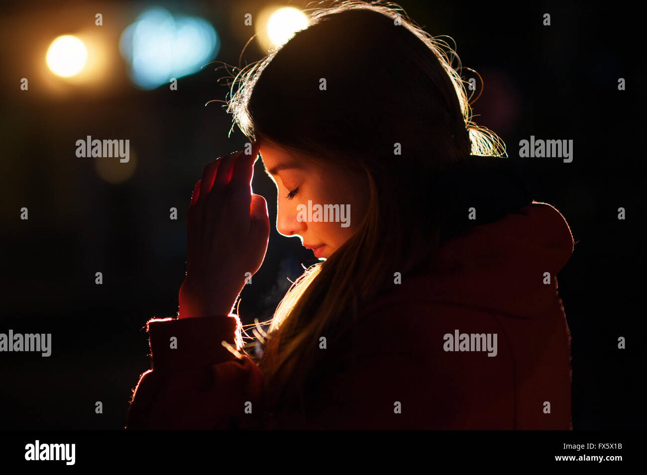 Closeup ritratto di una giovane donna che prega Foto Stock