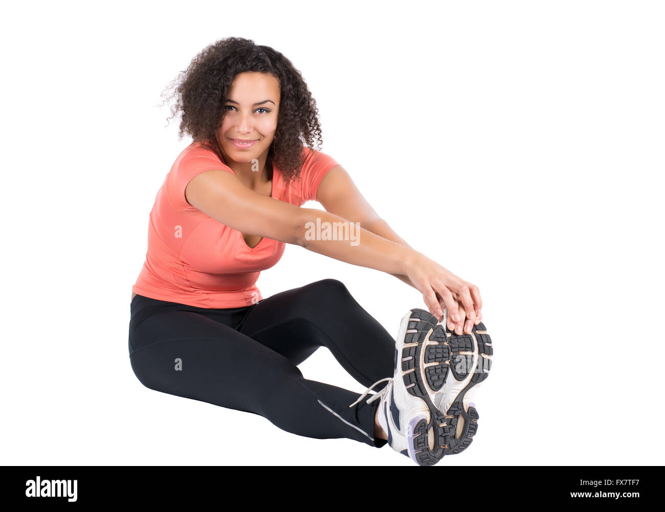 Tagliare l immagine di una giovane donna che si allunga la sua muscolatura Foto Stock