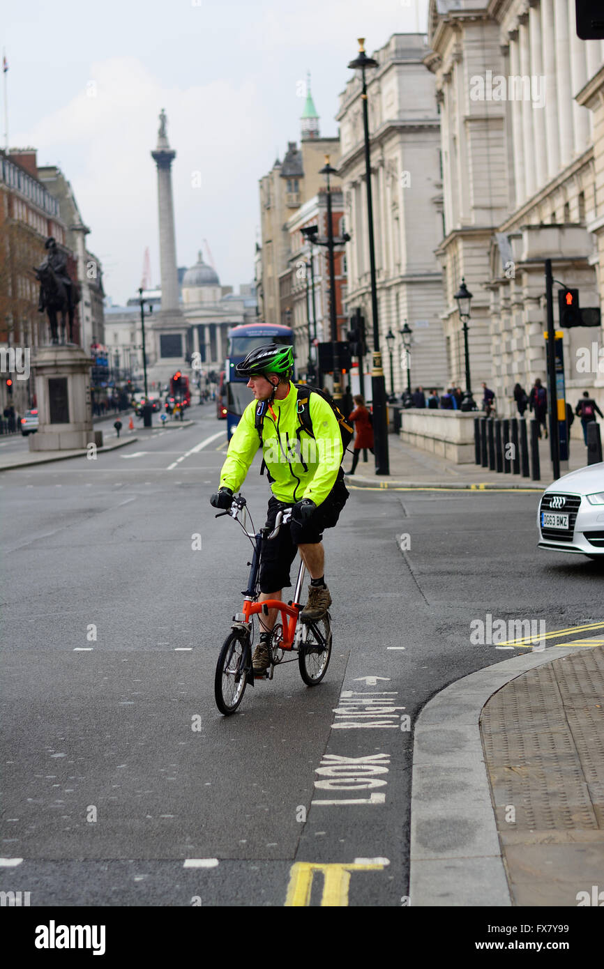 Ciclista girando a sinistra su un angolo di strada a Londra Foto Stock