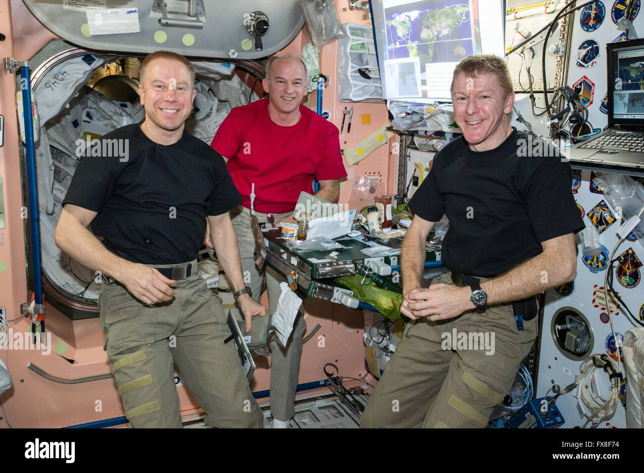 Stazione Spaziale Internazionale Expedition 47 membri di equipaggio astronauti americani Tim Kopra (sinistra) e Jeff Williams join astronauta britannico Tim Peake per la cena all'interno del modulo unità Aprile 5, 2016 in orbita intorno alla terra. Foto Stock